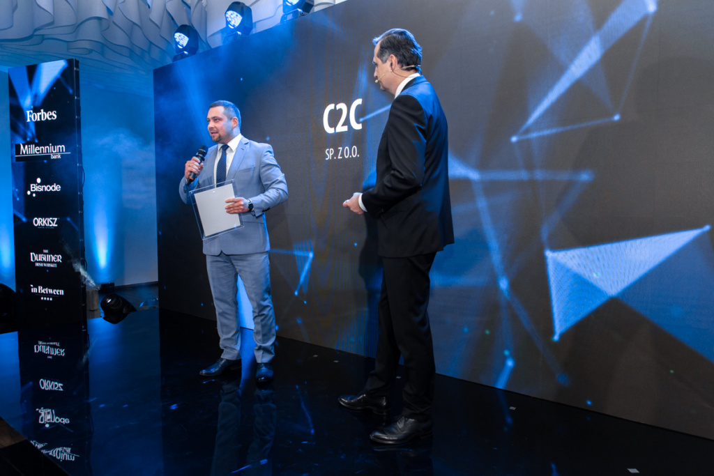 Businessman from C2C sp. z o. o. speaks to a host of Forbes Diamond event.