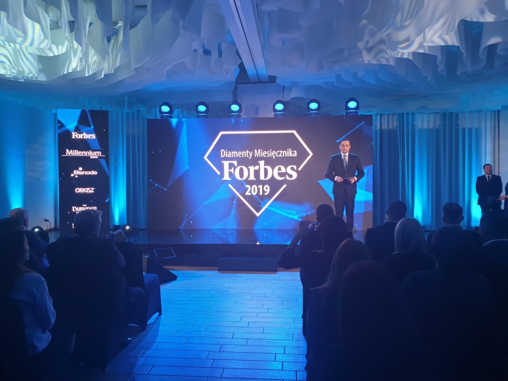 Host of event speaking to the audience during Forbes Diamonds 2019